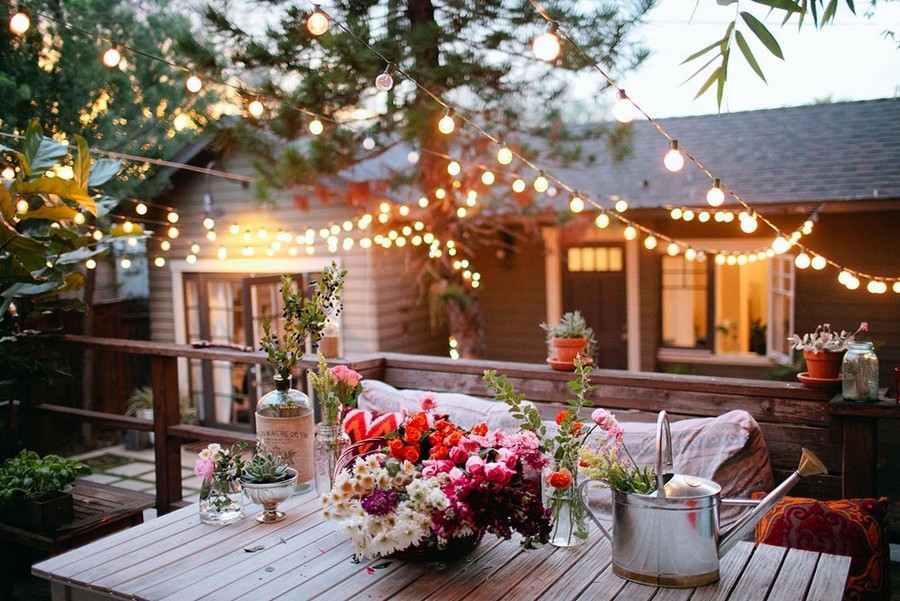 10 Simple Ideas to Give Your Backyard a Complete Makeover This Weekend, 4 4 outdoor garden landscape lighting ideas rope string holiday lights bulbs beautiful cozy table setting